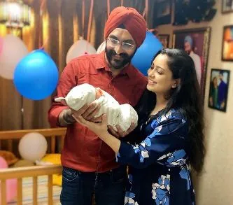 inside image of harshdeep kaur with husband and new born baby