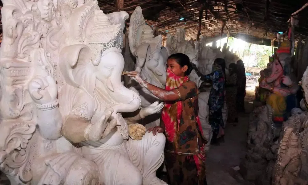 women making ganesh murti