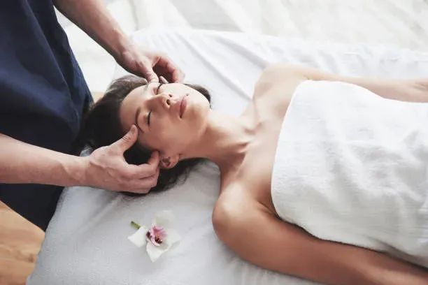 Young beautiful woman relaxing from the massage face.