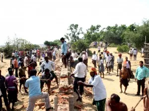 File pic: Nuagaon villagers pulling down Posco boundary wall ( pic-Binay K Ray )
