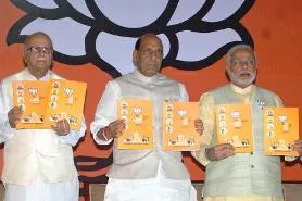 BJP veteran L K Advani, party president Rajnath Singh, party's Prime Ministerial candidate and Gujarat Chief Minister Narendra Modi and senior party leader Murli Manohar Joshi release BJP's manifesto for 2014 Lok Sabha Elections in New Delhi on April 7, 2014. (Photo: IANS)