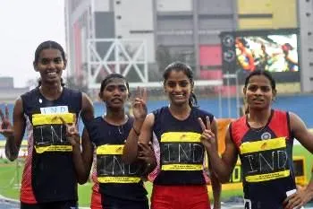 Dutee Chand (extreme Right) and her team mates flashing the 'V' sign after their win the 4 X 400 meter relay