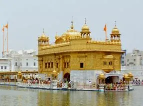 A Sikh Nihang wearing a huge turban pays obeisance at Golden Temple on the Martyrdom Day of Guru Arjun Dev in Amritsar on June 1, 2014. (Photo: IANS)