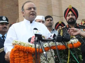 The Union Minister for Finance, Corporate Affairs and Defence, Shri Arun Jaitley addressing after laying wreath at Amar Jawan Jyoti, on the occasion of Kargil Vijay Diwas, in New Delhi on July 26, 2014. 	The Chief of Army Staff, General Bikram Singh, the Chief of Naval Staff, Admiral R.K. Dhowan and the Chief of the Air Staff, Air Chief Marshal Arup Raha are also seen.