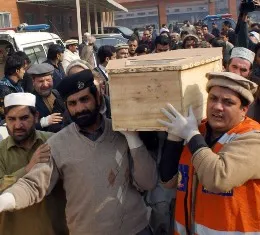 Pakistani volunteers move the coffin of a student from a hospital 