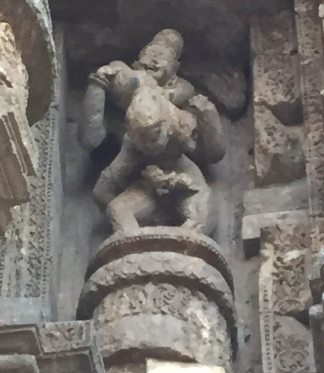 The Hanging Pose: The woman hanging from the shoulders of the man by her legs 