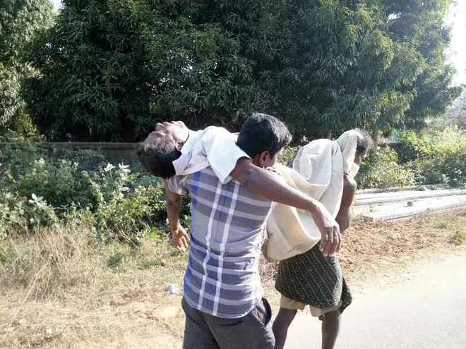man-carries-fathers-body
