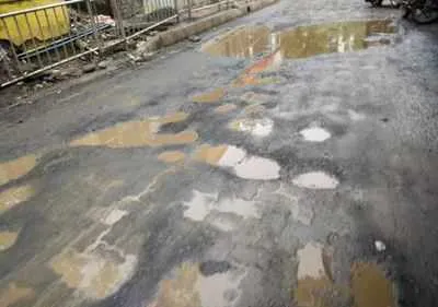 Image result for Man fills potholes after son dies in pothole-related accident