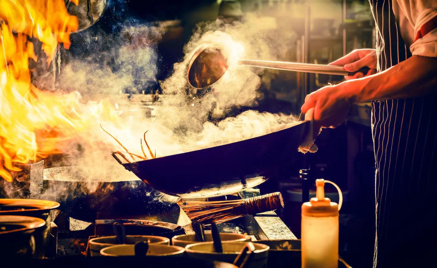 cooking vegetables in a flaming wok