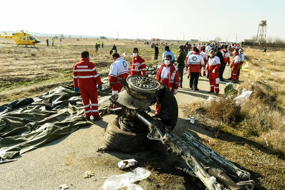 Rescue workers recover the bodies of victims of the wreckage of a Boeing Co. 737-800 aircraft, operated by Ukraine International Airlines, which crashed shortly after takeoff near Shahedshahr, Iran on Wednesday, January 8.