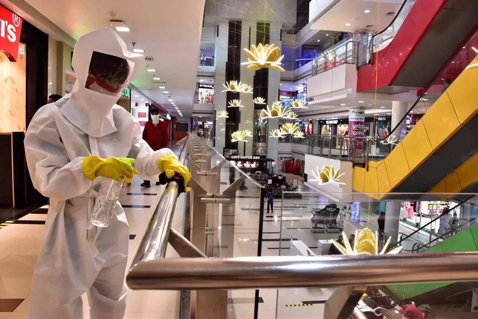 A worker, wearing PPE kit, sanitises a shopping mall amid the ongoing Covid-19 pandemic in Jabalpur on Saturday.