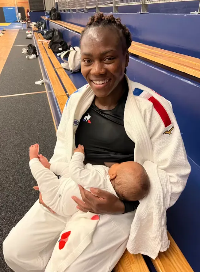 French judoka Clarisse Agbegnenou breastfeeds her baby in France in October 2022. (Nadia Benabdelouamed via AP)