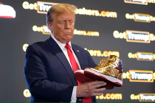 rump holds gold Trump sneakers at Sneaker Con Philadelphia, February 2024. AP Photo/Manuel Balce Ceneta