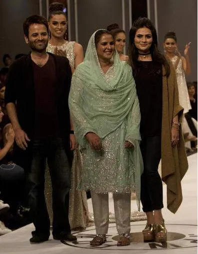 Pakistan's gang rape victim Mukhtar Mai walks on to stage during a fashion show in Karachi, Pakistan