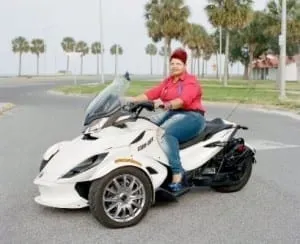 Women riding motorbike.