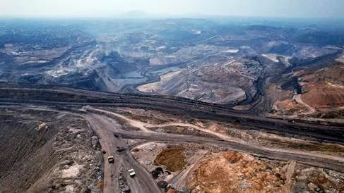 Aerial view of a road in a rocky areaDescription automatically generated