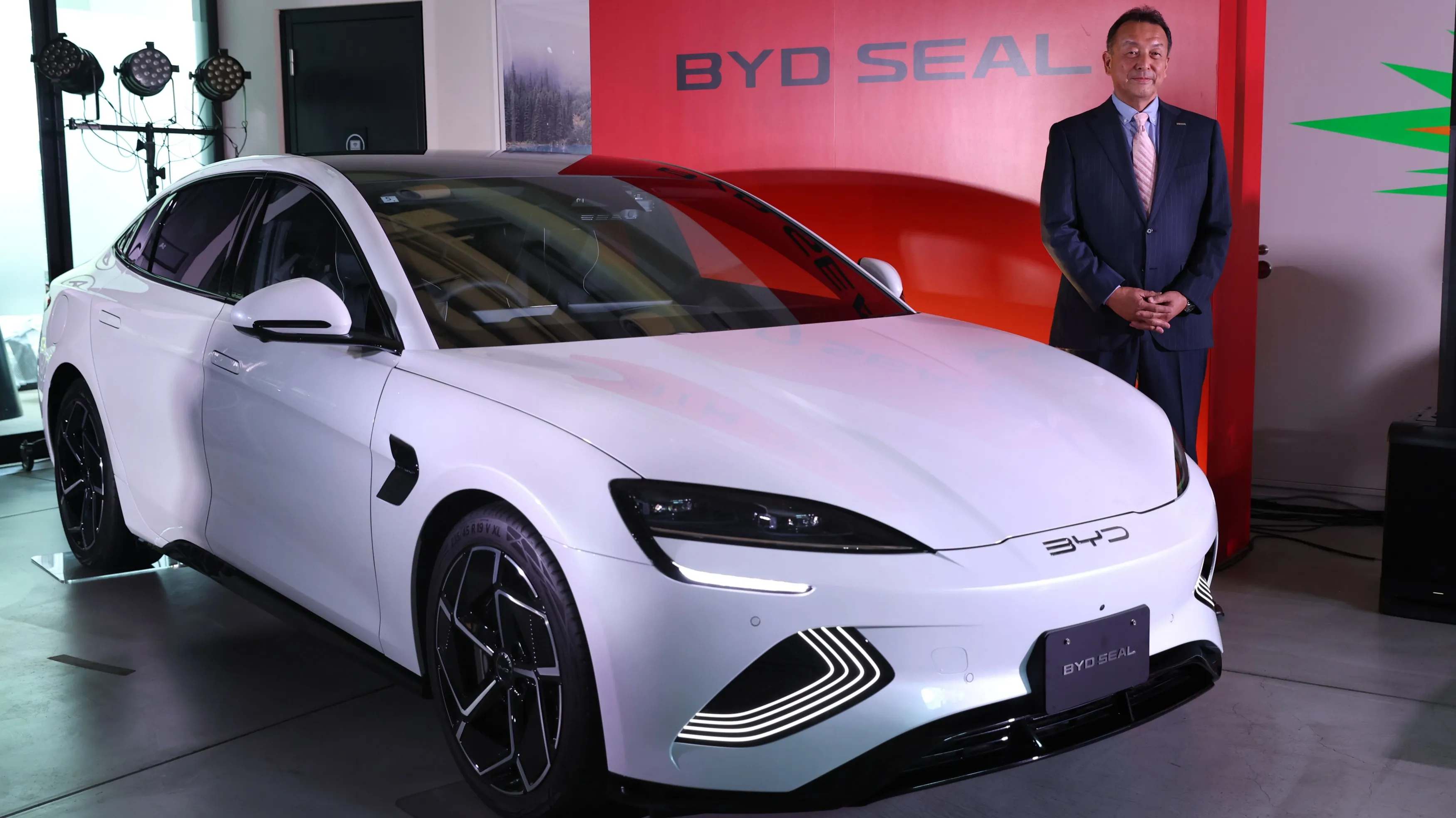 BYD Auto Japan President Atsuki Tofukuji stands by a Seal model sedan on June 25: The Seal is the first sedan offered in Japan by the Chinese EV maker. (Photo by Akitoshi Sugiura)