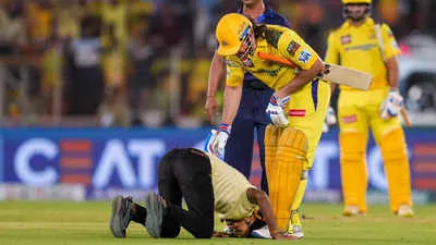 Watch: Fan breaches security, bows down in front of MS Dhoni | Cricket News  - Times of India