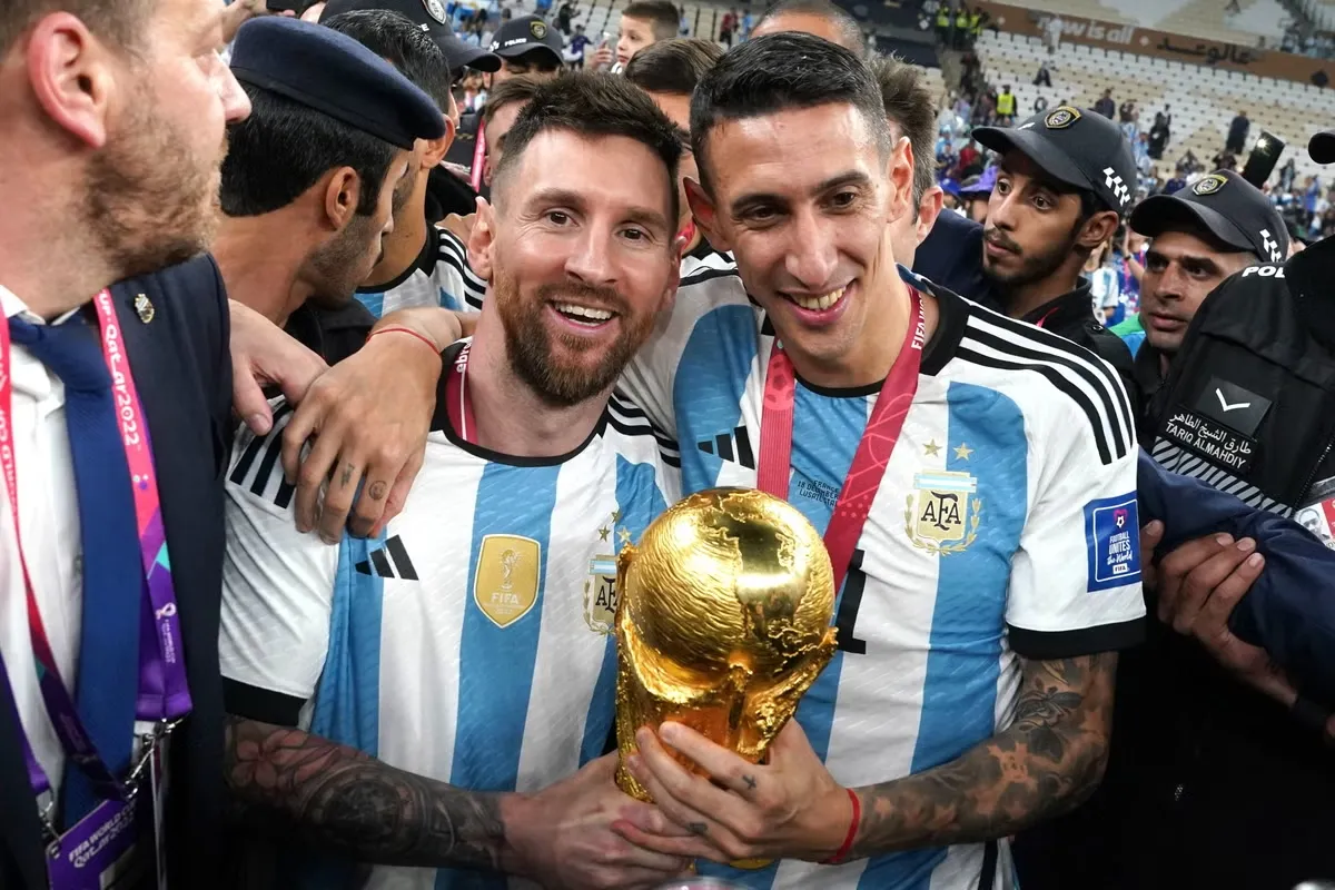 Football at Olympics: Messi and Di Maria holding the World Cup trophy -sportzpoint.com