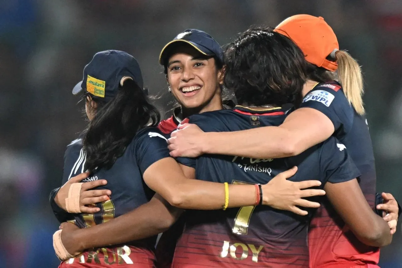 Smriti Mandhana gets a group hug from her team-mates  Image - AFP/Getty