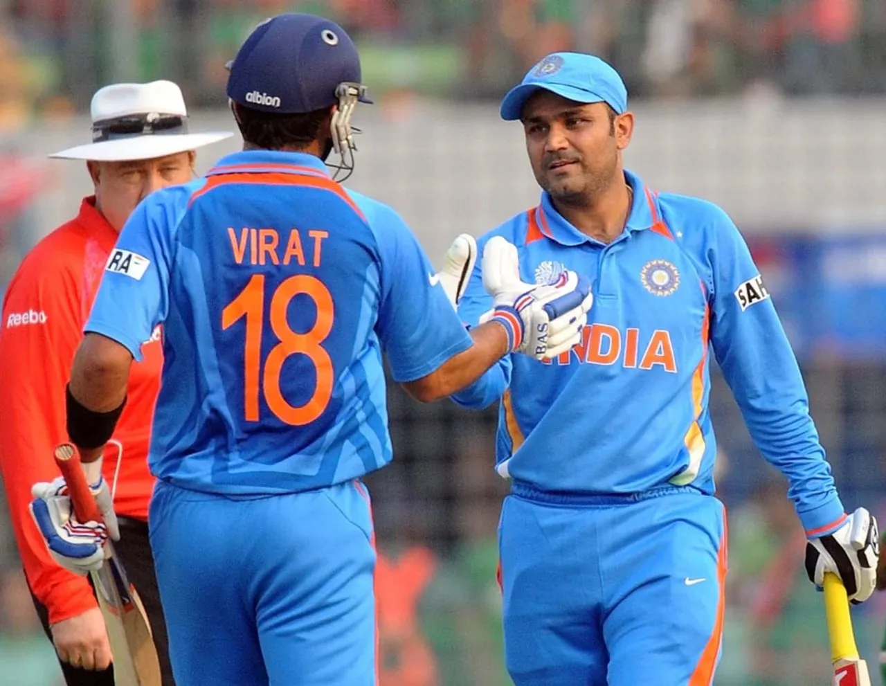 Virat Kohli congratulating Virender Sehwag on completing his hundred in just 94 balls in 2011 World Cup.  Image: AFP