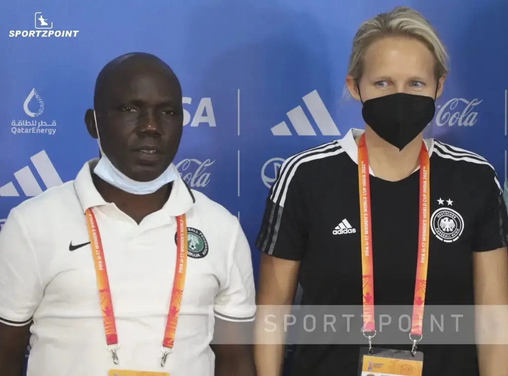 Nigeria vs Germany | Nigerian coach (left) and German coach pose for a photo after the press conference ahead of their clash for the Bronze medal in FIFA U17 Women's World Cup | Sportz Point