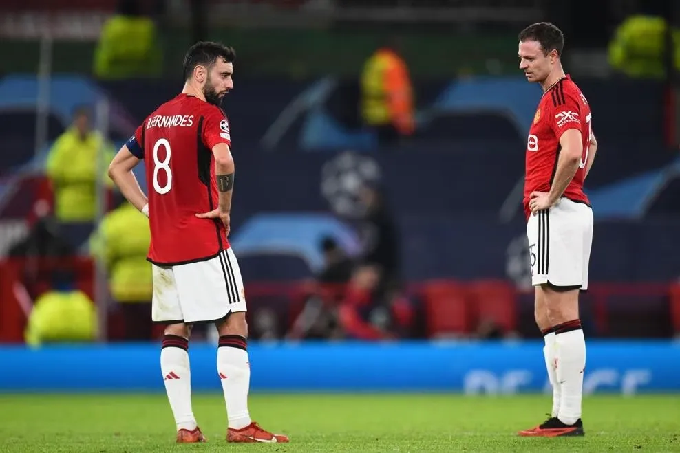 Manchester United players are in dejection after the loss against Bayern Munich.  