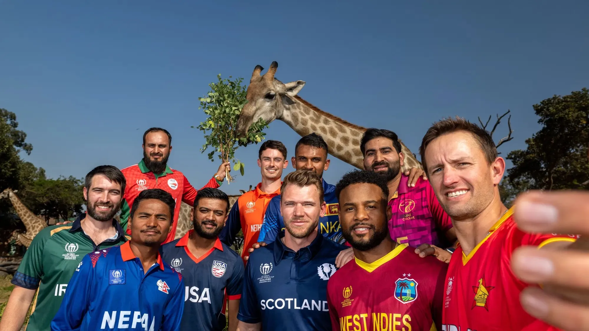 The captain's pose for a selfie during the Captain's Photocall prior to the ICC Men's Cricket World Cup Qualifier Zimbabwe 2023 at Wild is Life Sanctuary on June 16, 2023 in Harare, Zimbabwe.   Image | ICC