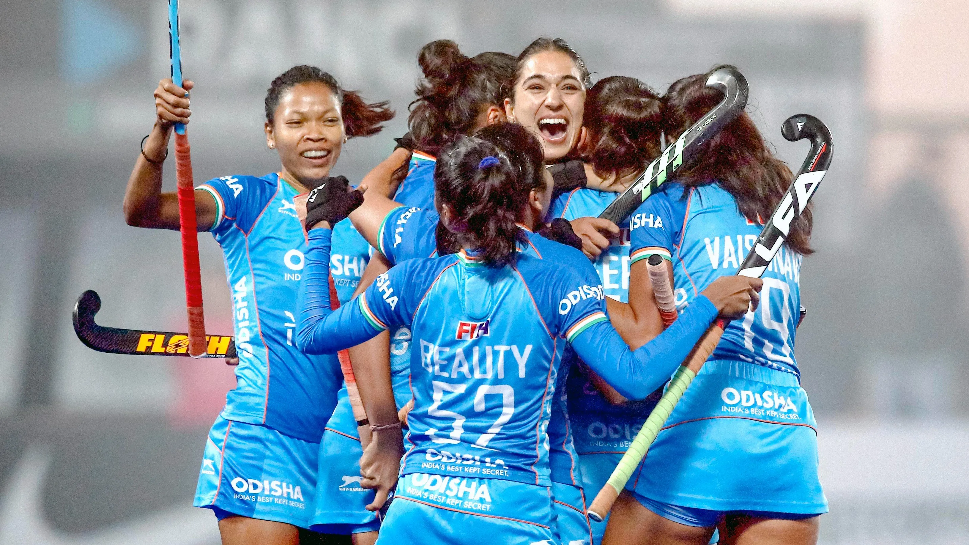 Indian women's hockey team players celebrating their goal.  Adimazes Pvt Ltd