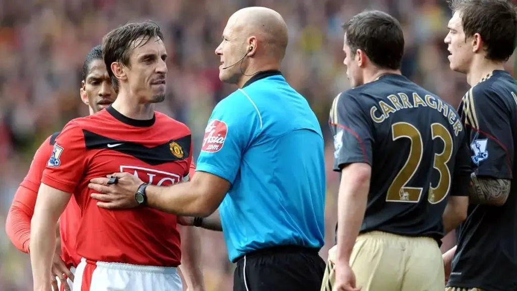 Liverpool vs Man United: The most bitter Rivalry in English Football: Referee Howard Webb holding Manchester United defender Gary Neville from Liverpool defender Jamie Carragher, 2010 | Sportz Point