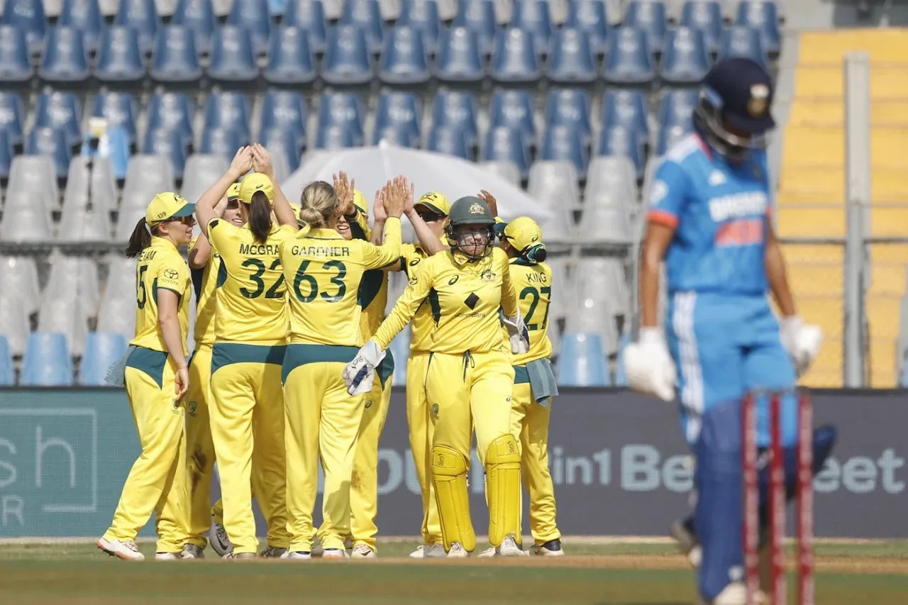 Australian team celebrating the wicket of Harmanpreet Kaur in the first ODI between India and Australia.  Image | Getty Images