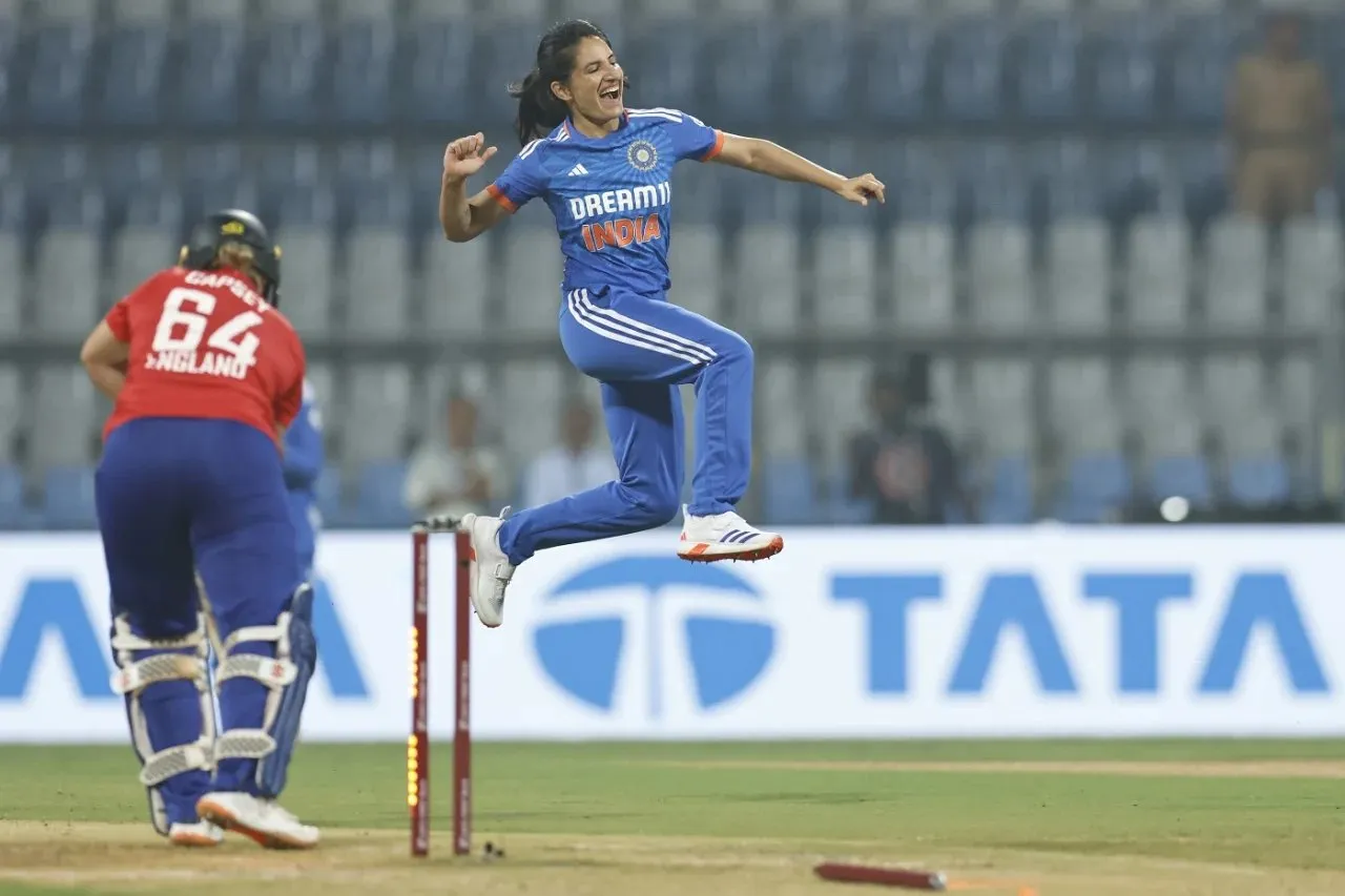 Renuka Singh in joy after getting Alice Capesy's wicket in the first over of the INDW vs ENGW 1st T20I in Mumbai.  Image | BCCI