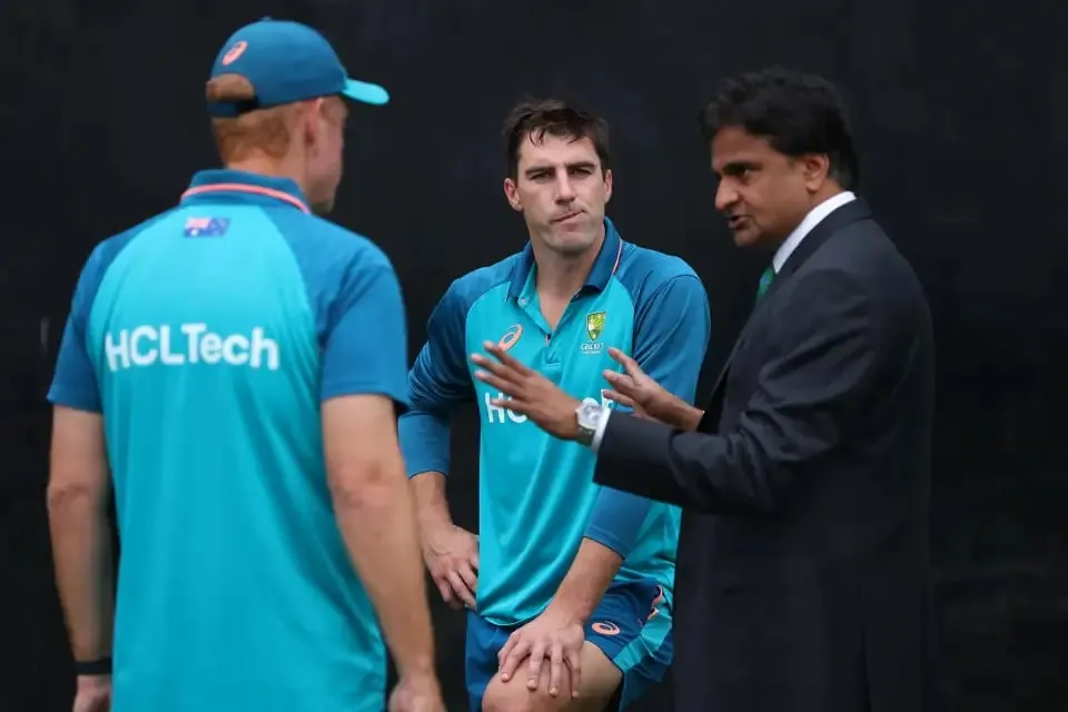Pat Cummins and Andrew McDonald are having a chat with match referee Javagal Srinath  Getty Images