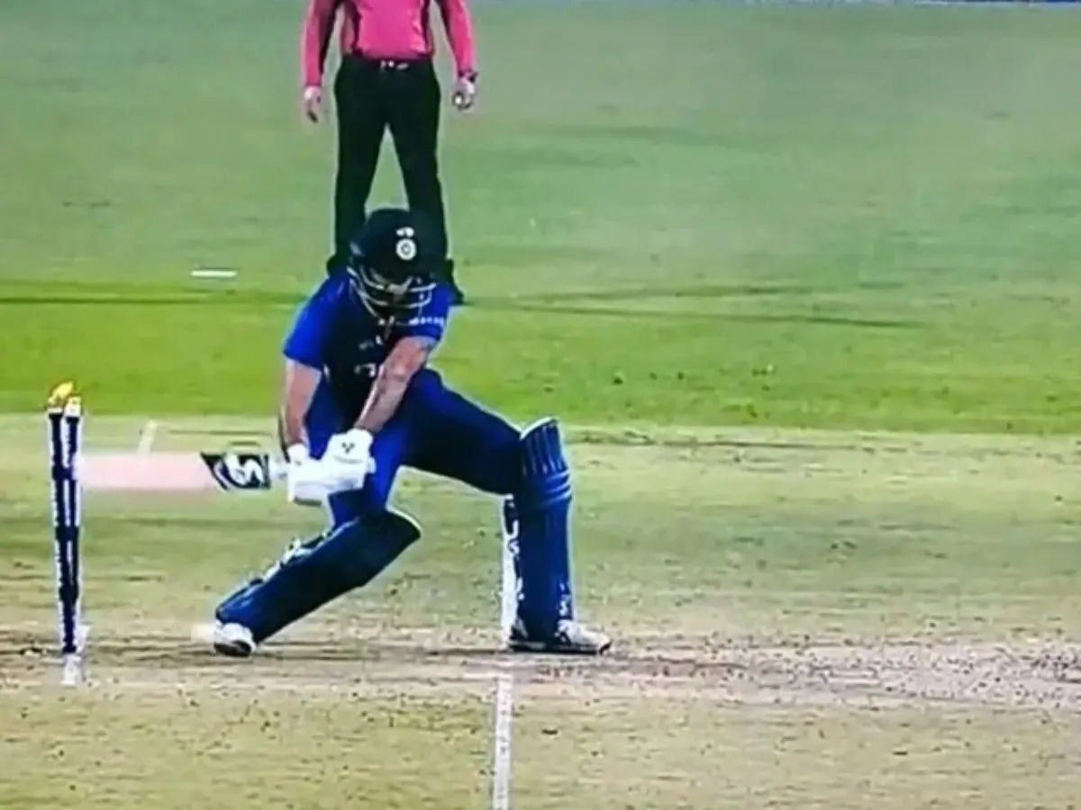 Harshal Patel hitting the stumps with his bat while trying to hit a slower ball from Lockie Ferguson.  