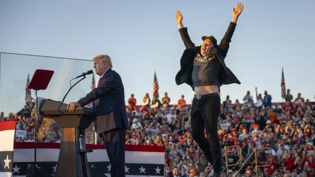  File Photo: Tesla CEO Elon Musk (R) jumps on stage as he joins Donald Trump during a campaign rally at site of his first assassination attempt in Butler, Pennsylvania on October 5, 2024. Photograph: (AFP) 