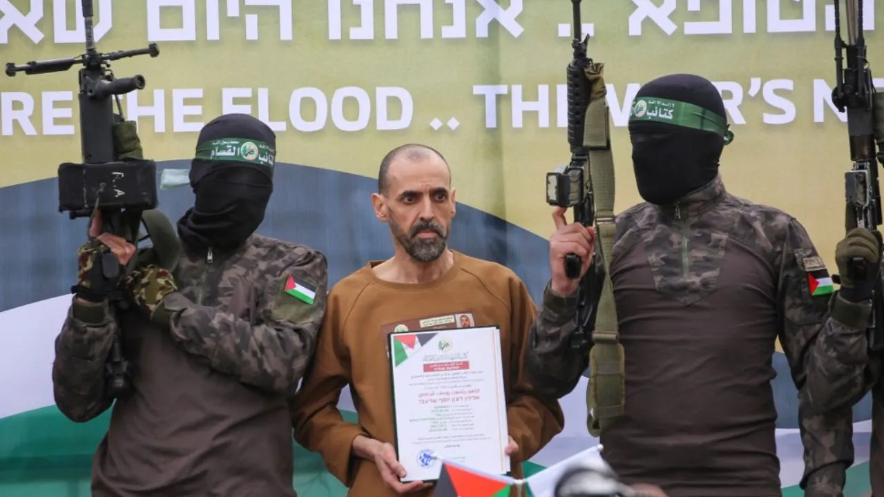  Hamas fighters escort Israeli hostage Eli Sharabi on a stage before handing him over to a Red Cross team in Deir el-Balah, central Gaza, on February 8, 2025.  Photograph: (AFP) 