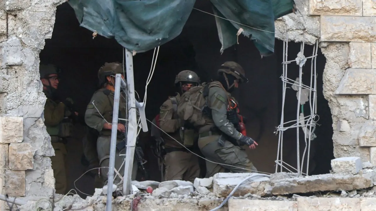  Israeli soldiers check the house of Palestinian man accused of an attack against Israelis in October 2024 in Jaffa, after the army used explosives to destroy the interior of the building, in Hebron in the occupied west Bank on March 5, 2025. Israel has a policy of demolishing the homes of Palestinians accused of deadly attacks against Israelis, saying it acts as a deterrent. Photograph: (AFP) 