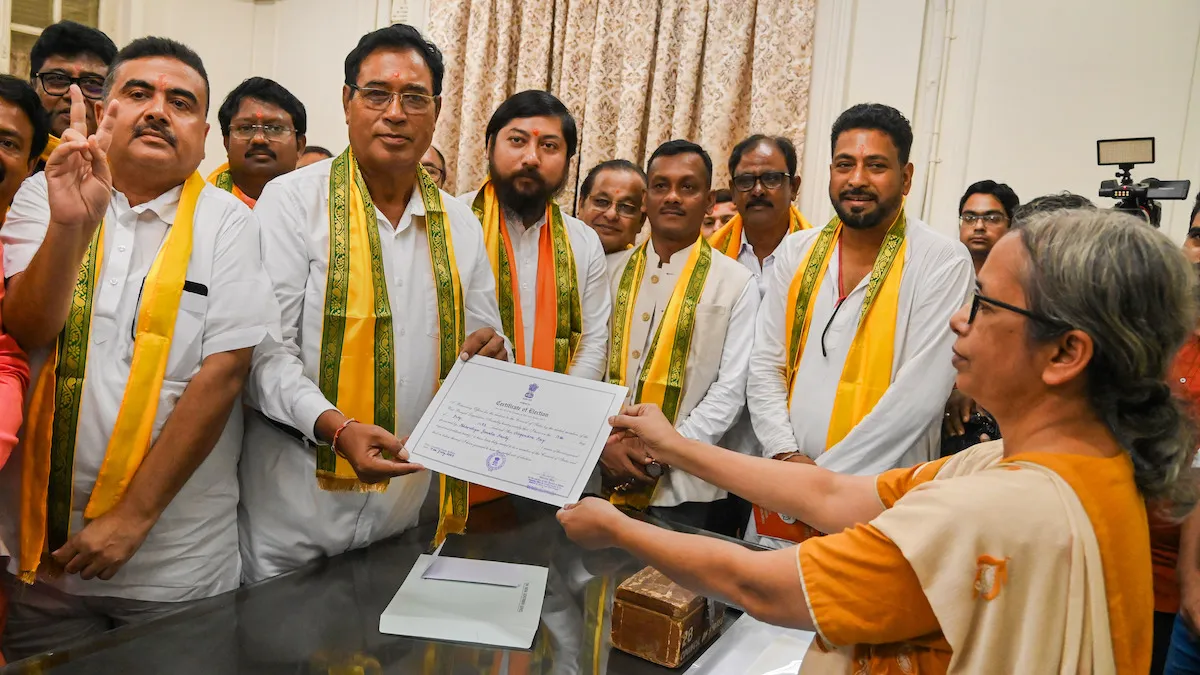 BJP Rajya Sabha winning candidate Ananta Barman Maharaj (2nd L) receives his certificates as Leader of Opposition in WB Assembly Suvendu Adhikari (L), Union Minister of State for Home Affairs Nishit Pramanik and others look on, at West Bengal Legislative Assembly, in Kolkata, Monday, July 17