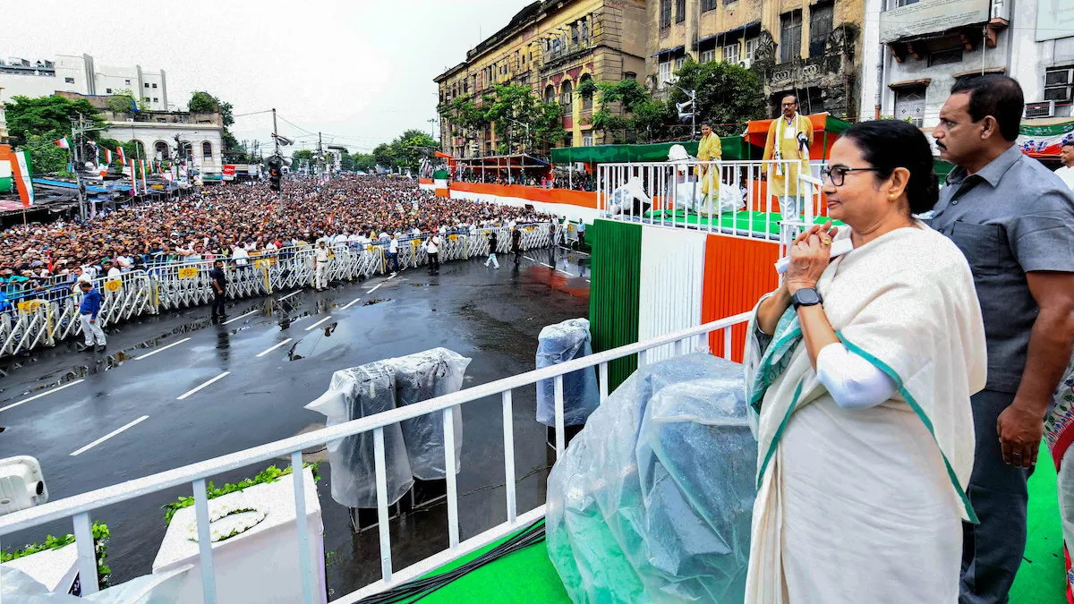 West Bengal Chief Minister and TMC chief Mamata Banerjee greets supporters during the party's Martyrs' Day rally amid rain, in Kolkata, Friday, July 21