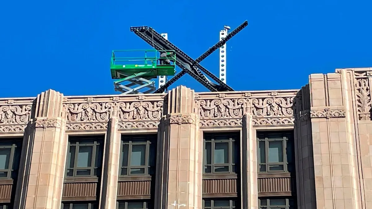 X logo atop twitter building
