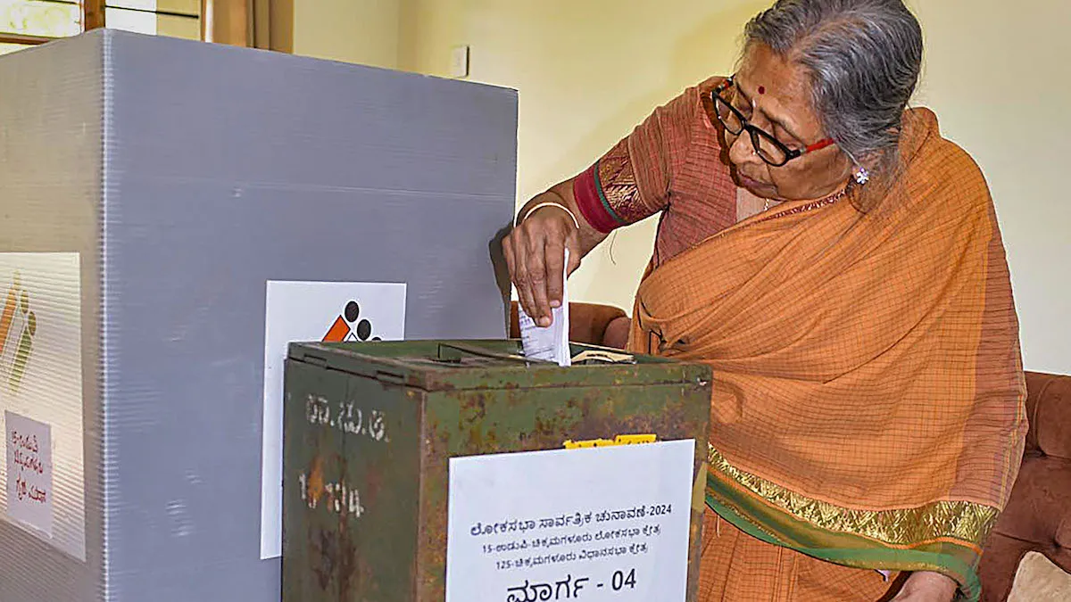 A senior citizen casts her vote via postal ballot, for the Lok Sabha elections, in Chikkamagaluru, Karnataka, Monday, April 15, 2024.