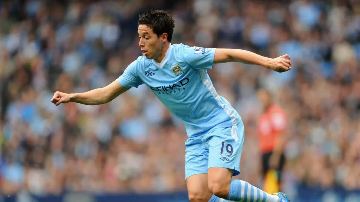 Nasri in Mancity's trademark light blue jersey contesting for the ball