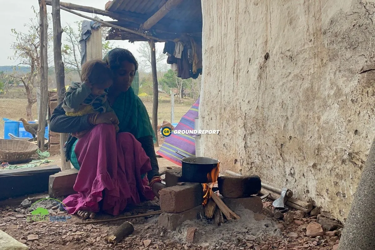 Woman Cooking on fire wood chulha in India