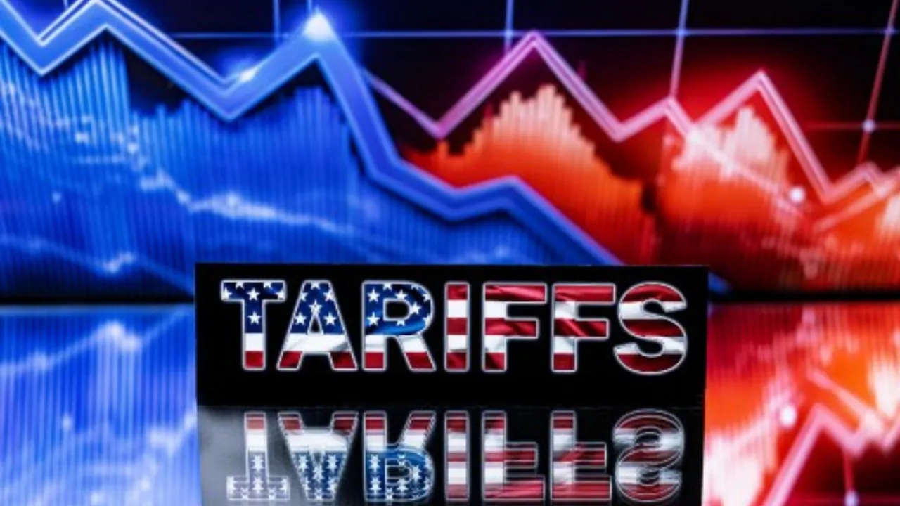  This illustration photograph shows a screen displaying a stock market index graphs and the word "Tariffs" written in the colours of the US flag. Photograph: (AFP) 