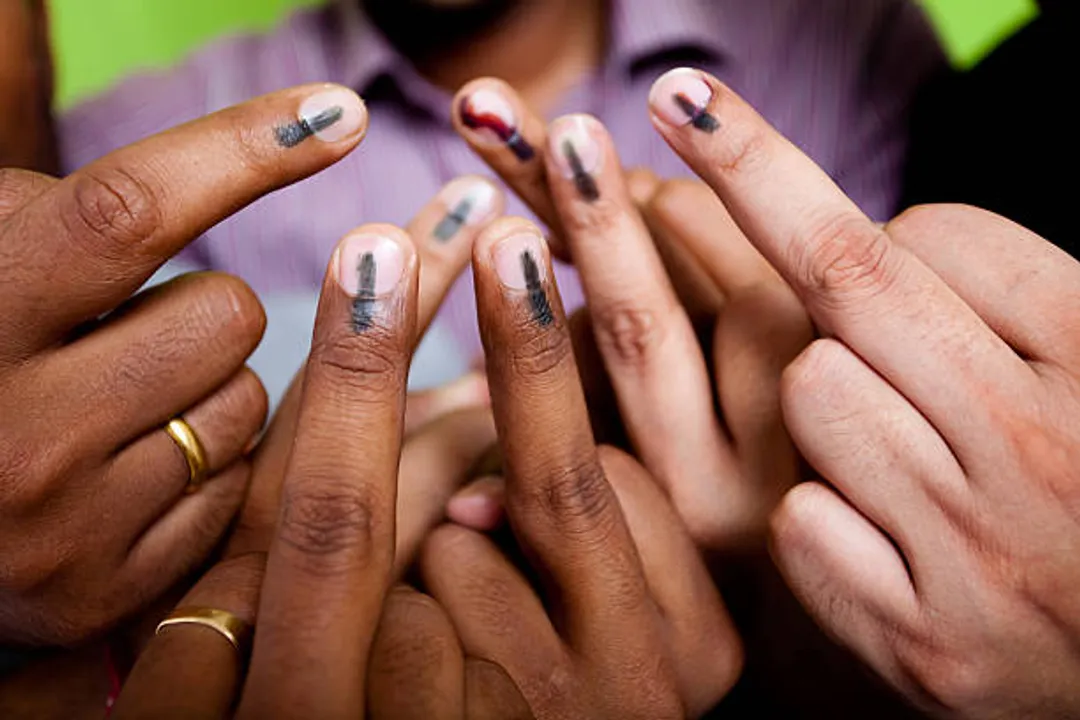  Indian youths showing their mark after voting in the General Elections in India. This mark is an indication that the person has cast it's Vote 