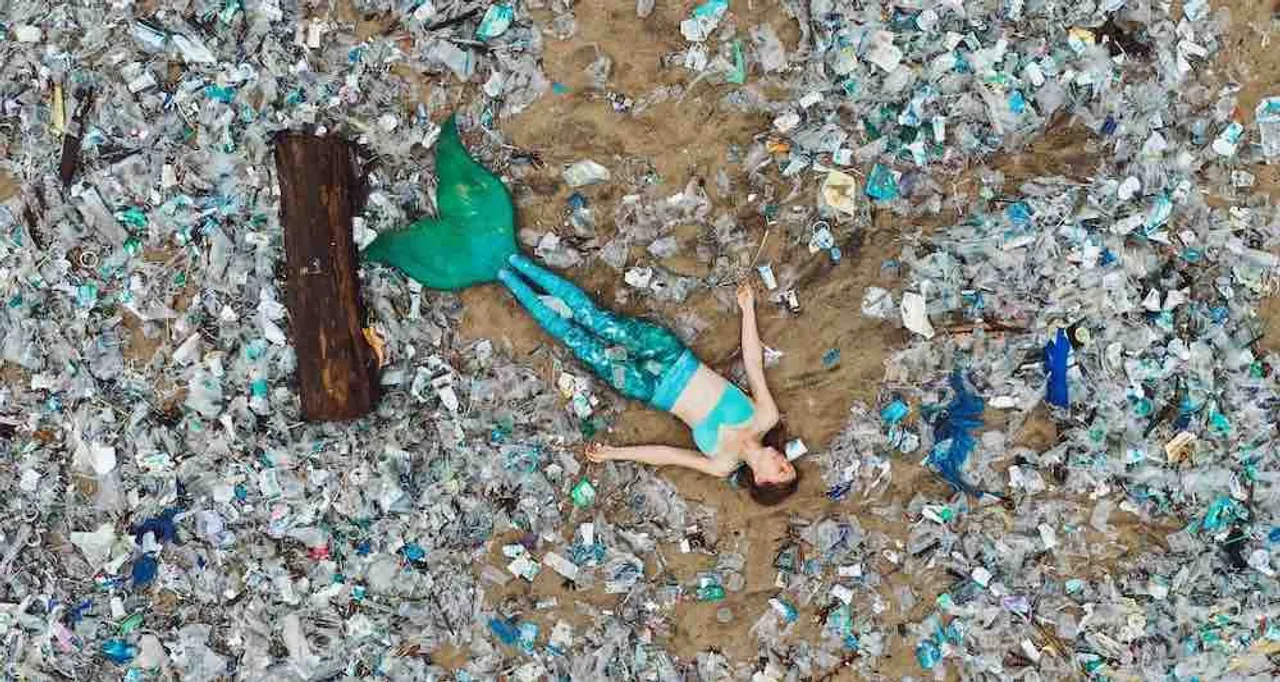 Mermaid Protest: Activist dressed as Mermaid lies on Beach filled with Plastic