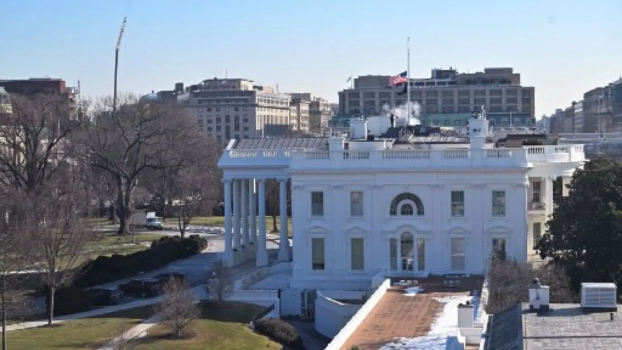  Video shows man dressed in black climbing White House security fencing before being caught by Secret Service Photograph: (AFP) 
