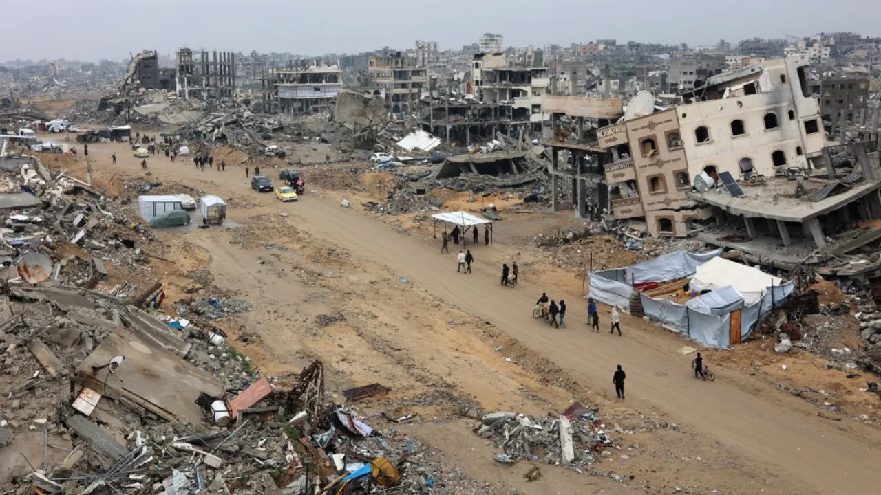  People walk amid collapsed buildings along Saftawi street in Jabalia in the northern Gaza Strip on February 5, 2025 during a ceasefire deal in the war between Israel and Hamas. Palestinian militant group Hamas lashed out on February 5, at President Donald Trump's shock proposal for the United States to take over the Gaza Strip and resettle its people in other countries, seemingly whether they want to leave or not. Photograph: (AFP) 