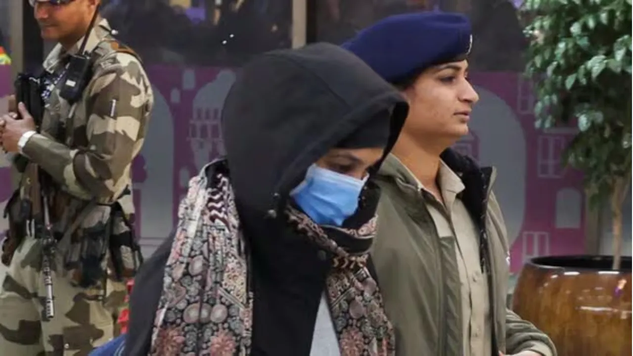  Police escort an Indian immigrant deported from the U.S. as they leave the airport in Ahmedabad  Photograph: (Reuters) 