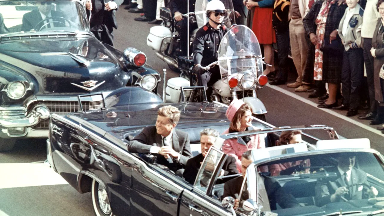  File Photo: President Kennedy in the limousine in Dallas, Texas, on Main Street, minutes before the assassination. Also in the presidential limousine are Jackie Kennedy, Texas Governor John Connally, and his wife, Nellie. Photograph: (Wikimedia Commons) 